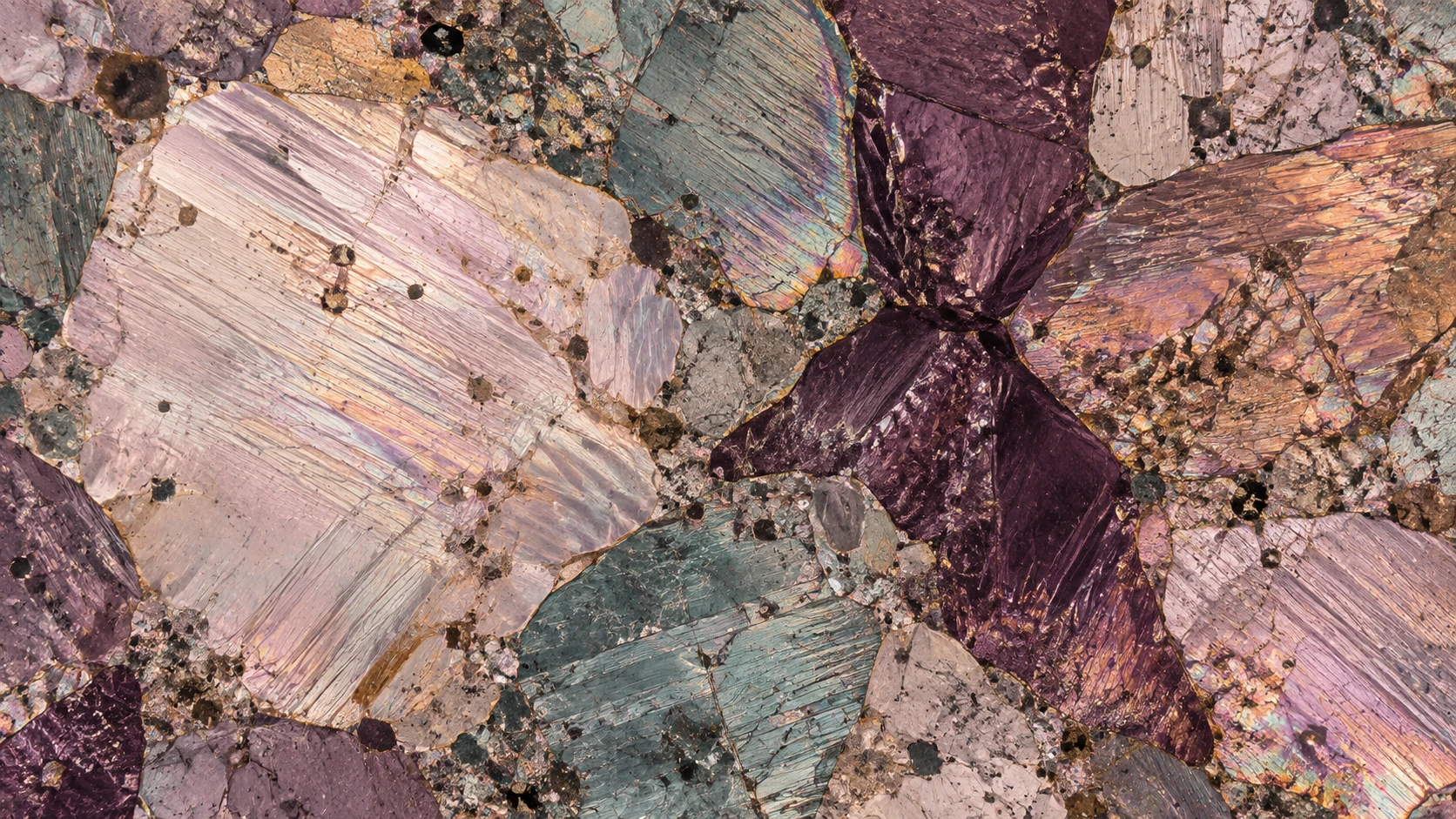 A mineral field in plum, copper and teal, in the style of polarized-light microscopy.